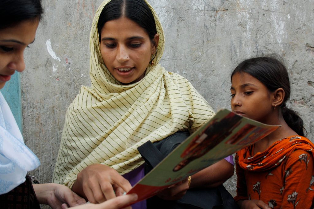 Photo of a community health worker conducting a survey in the Korail slum, Bangladesh