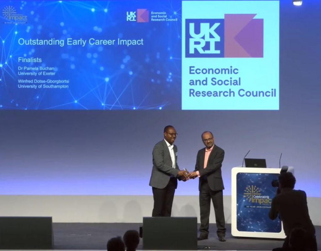 Winfre Dotse-Gborgbortsi receiving runner-up prize at the ESRC Celebrating Impact Prize 2022 ceremony