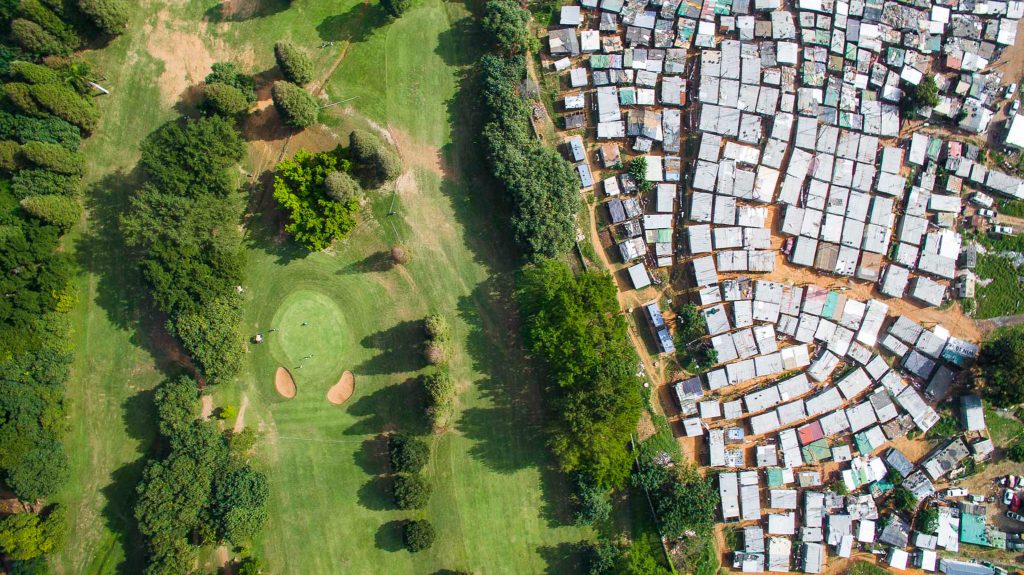 Drone view of village in South Africa bordering a golf course.