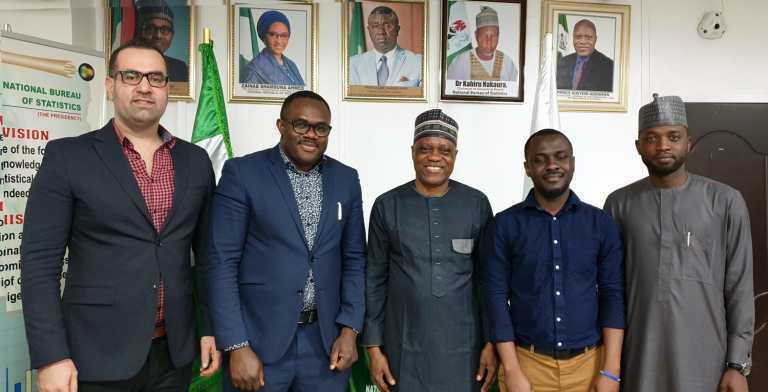 Photo of Chris Nnanatu, Sarchil Qader and Ortis Yankey with Semiu Adeyemi Adeniran (centre), Statistician-General of the Federation and Chief Executive Officer of the National Bureau of Statistics, and Muhammad Nazir Haliru (GRID3 Nigeria Country Manager). Abuja, Nigeria,