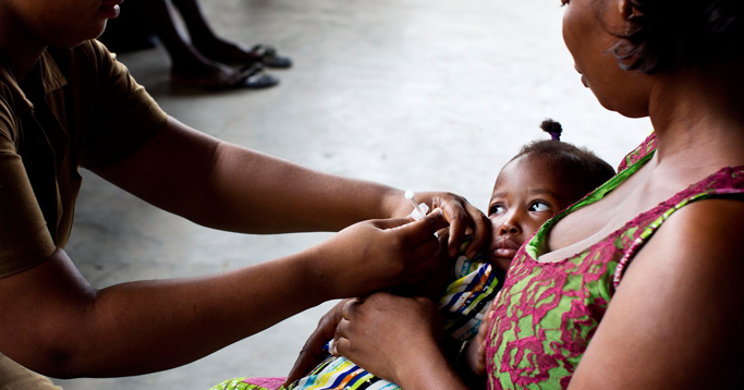 A nurse vaccinates a baby at a clinic in Accra, Ghana.