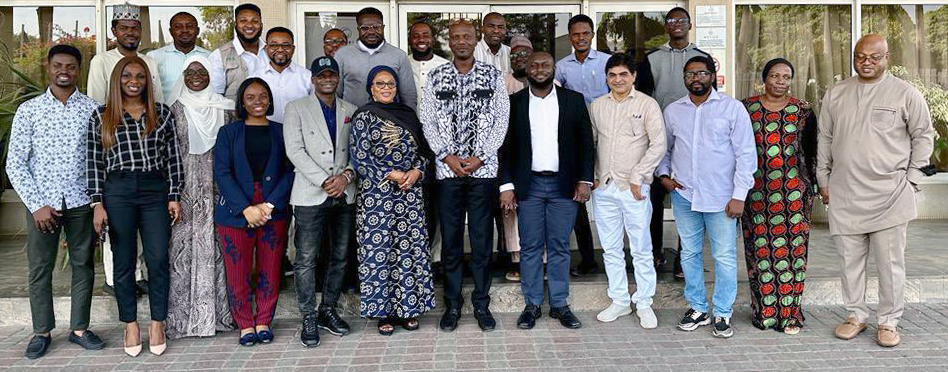 Photo of Dr Edson Utazi and Iyanuloluwa Olowe with VaxPop Nigeria workshop participants