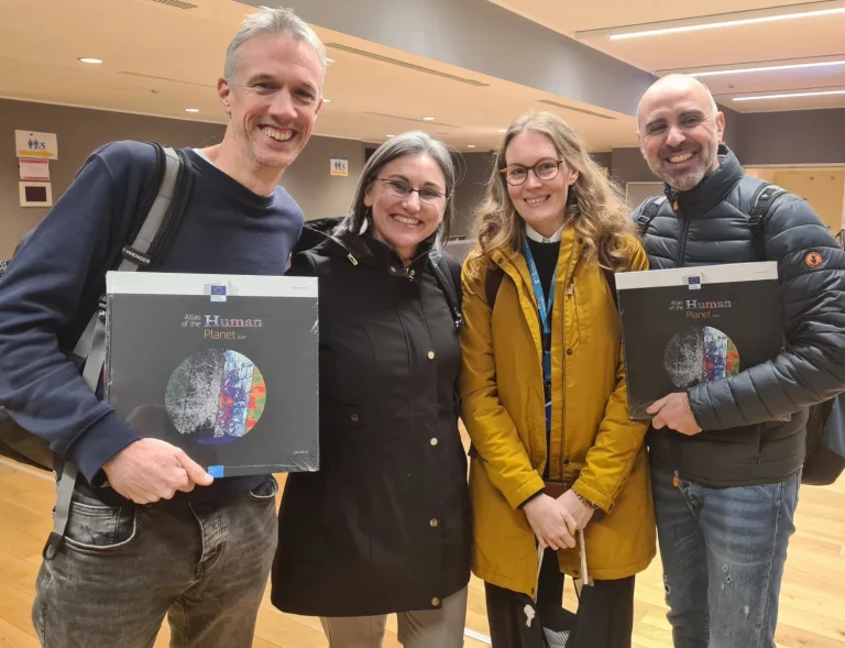 Photo of Professor Andy Tatem with Dr Dana Thomson (CIESIN), Dr Alessandra Carioli (European Commission) and Associate Professor Alessandro Sorichetta (University of Milan) with copies of Atlas of The Human Planet, 2024.