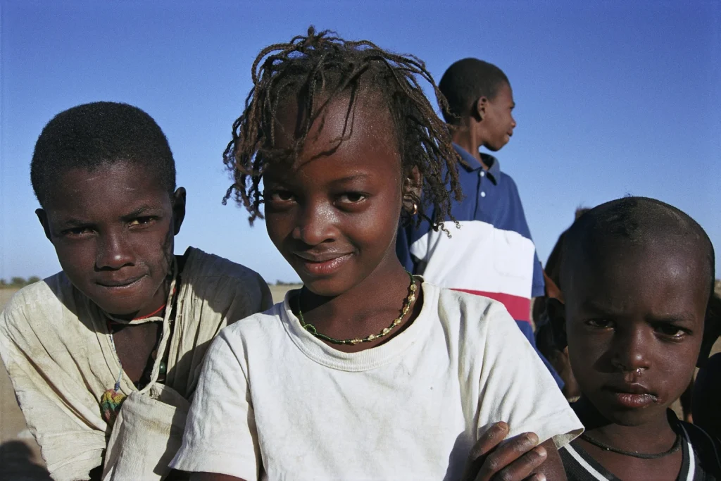 Photo of four children in a small village in Senegal