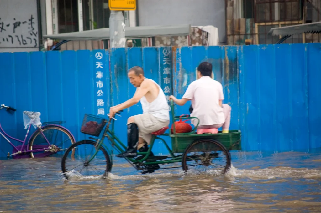 Photo of cyclist in flooded street