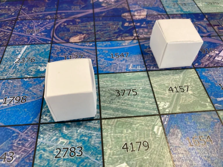 Photo of paper origami cubes places on a map