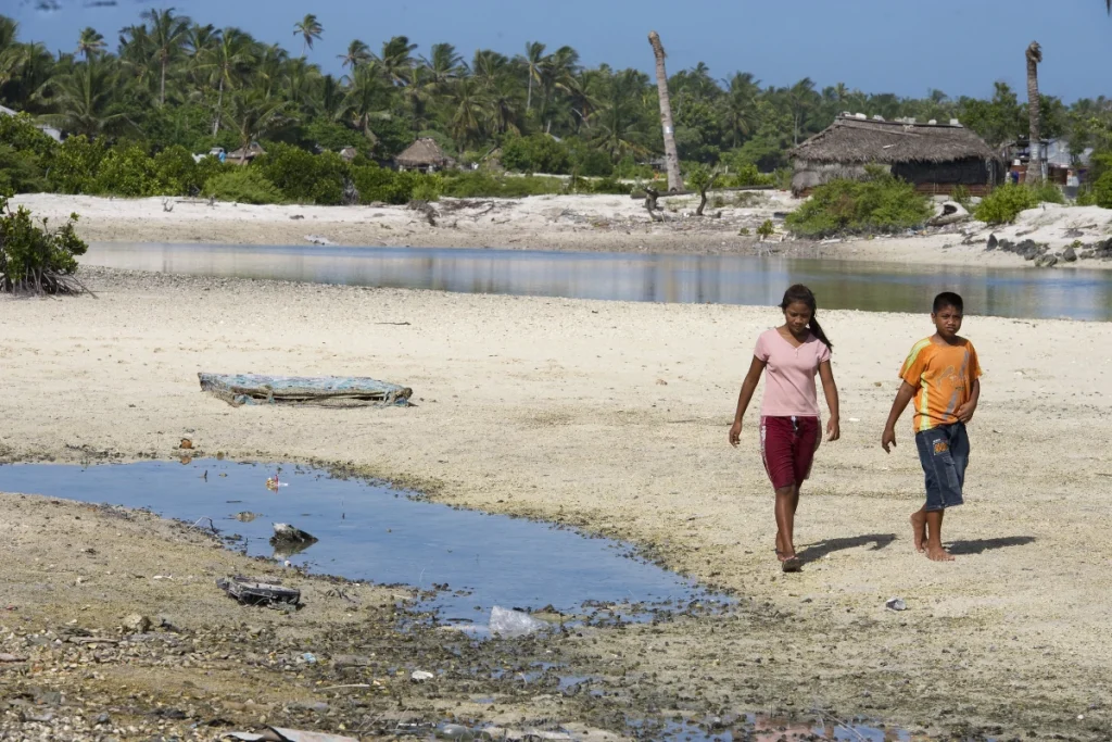 Photo of Locals in Tebikenikora, a village in the Pacific island nation of Kiribati.