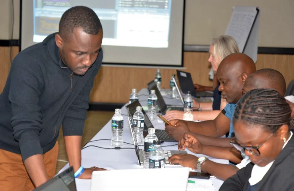 Photo of Dr Ortis Yankey supporting participants of workshop for Malawi’s 2028 Census, September 2026.