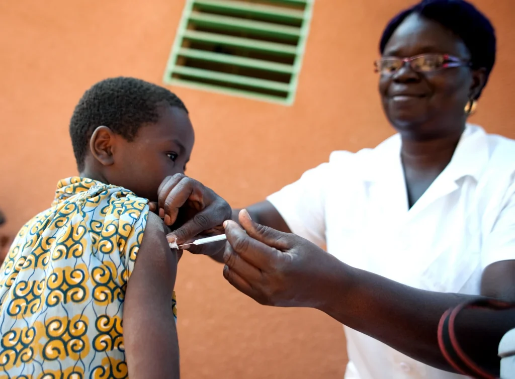 Photo of boy being vaccinated by nurse.