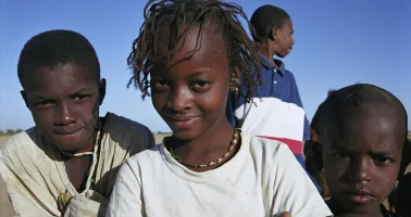 Photo of four children in a small village in Senegal