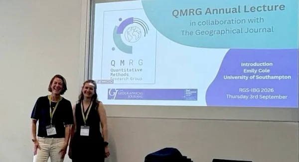 Photo of Dr Jessica Espey with Emily Cole at the QRMG Annual Lecture, 2026.