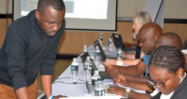 Photo of Dr Ortis Yankey supporting participants of workshop for Malawi’s 2028 Census, September 2026.