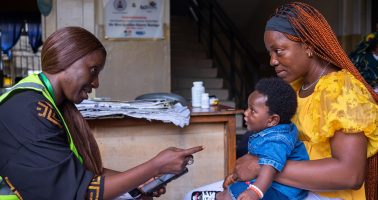 Photo of an Adhoc Registrar, supporting a mother during a digital birth registration drive in Port Harcourt, Nigeria, part of a nationwide effort to ensure every child has a legal identity
