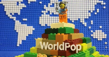 AI generated image of Lego minifigure on a brick mountain plus the WorldPop logo