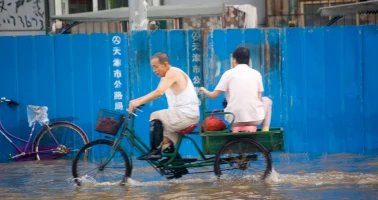 Photo of cyclist in flooded street