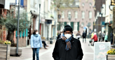 Photo of man wearing mask in street