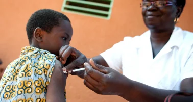 Photo of boy being vaccinated by nurse.